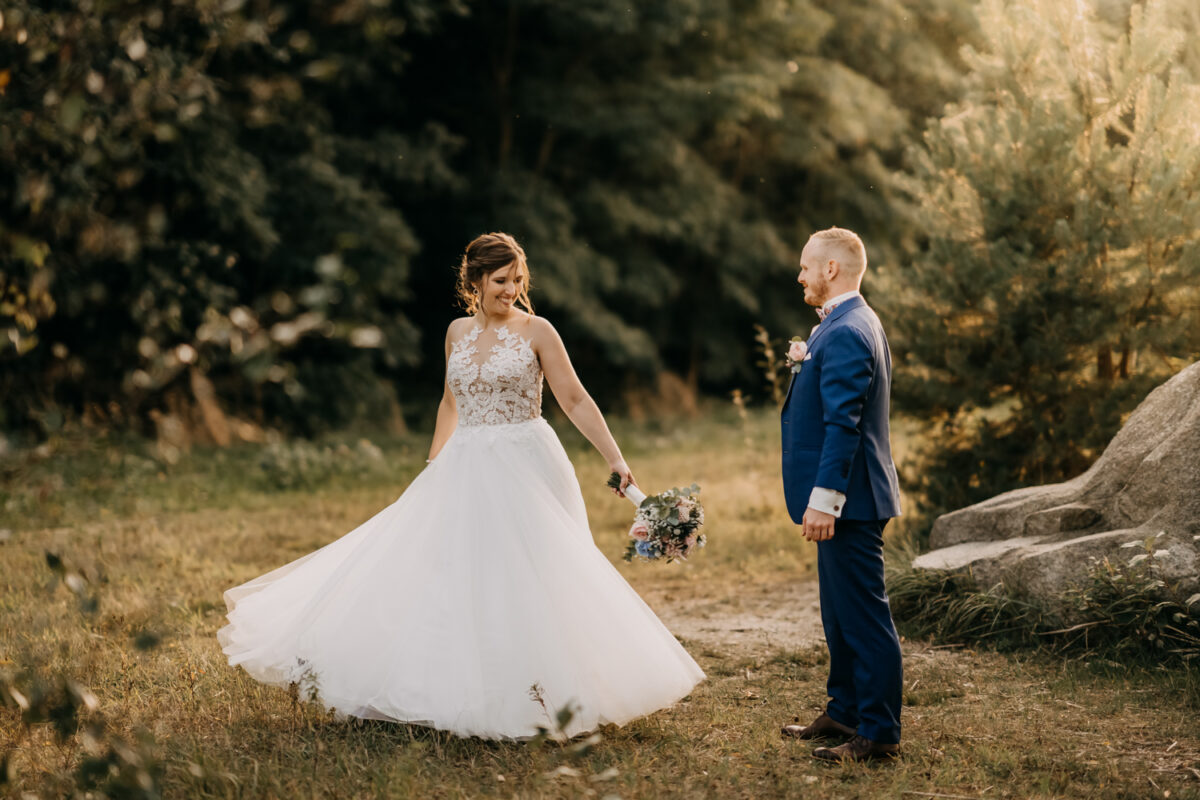 a man and woman in a blue suit and white dress